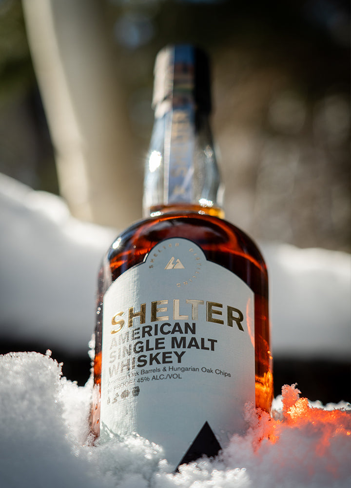 American Single Malt Whiskey in the Snow Enjoying a day of adventure and a monent in the woods.