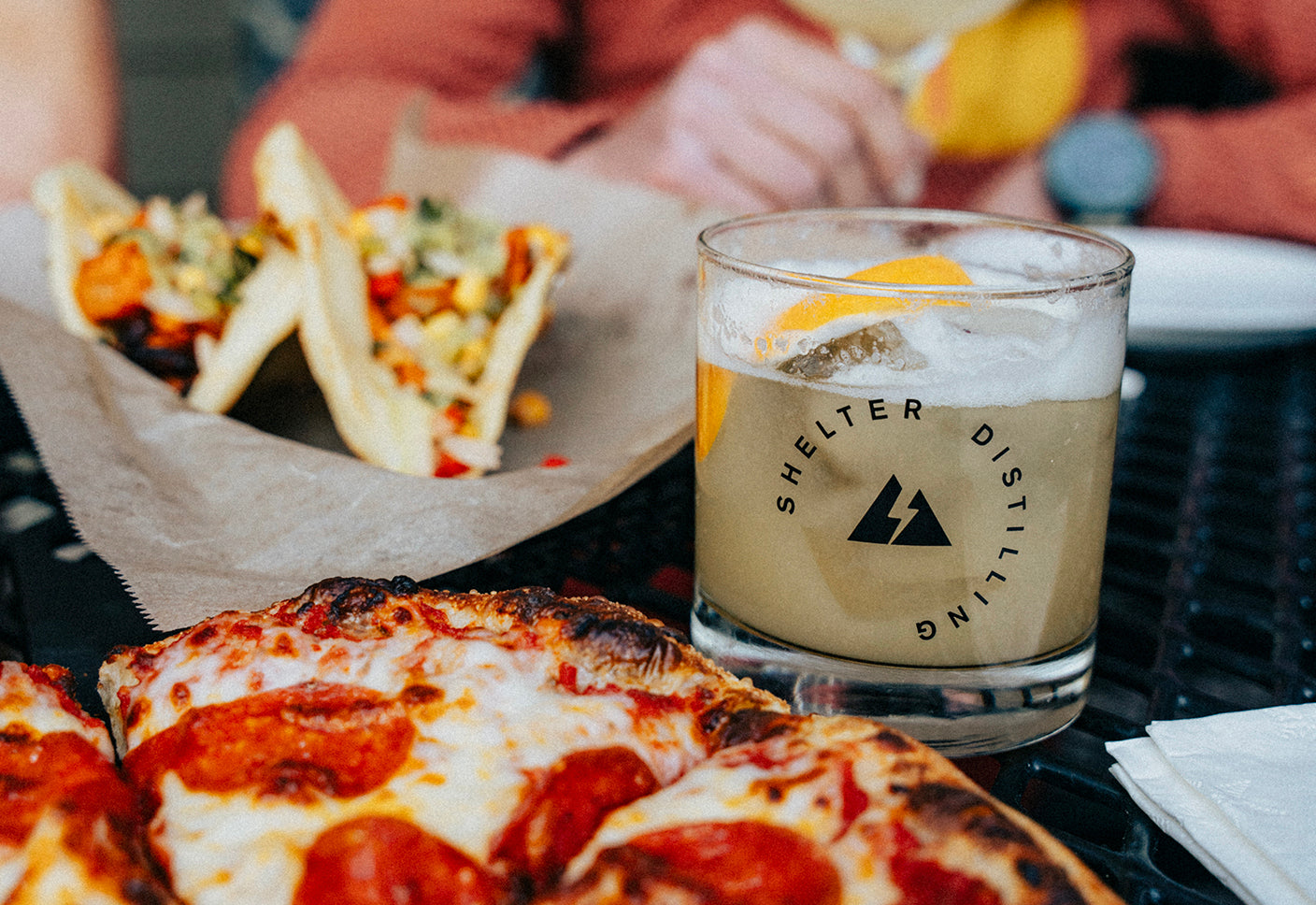 Maple Whiskey Sour at Shelter Distilling with pizza and tacos. Distillery, Brewery, and Kitchen in Mammoth Lakes, CA