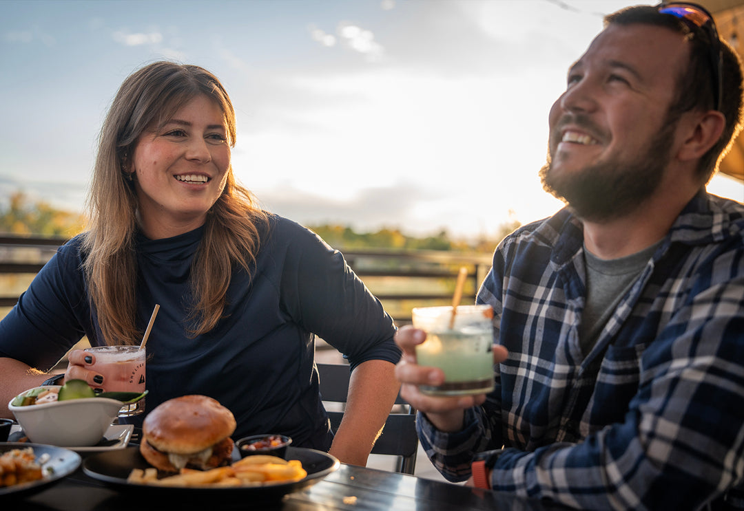 Shelter Distilling enjoying craft cocktails, craft beer, and amazing food. Burgers, frys, on the paito river front along the Uncompahgre River. Happy Hour