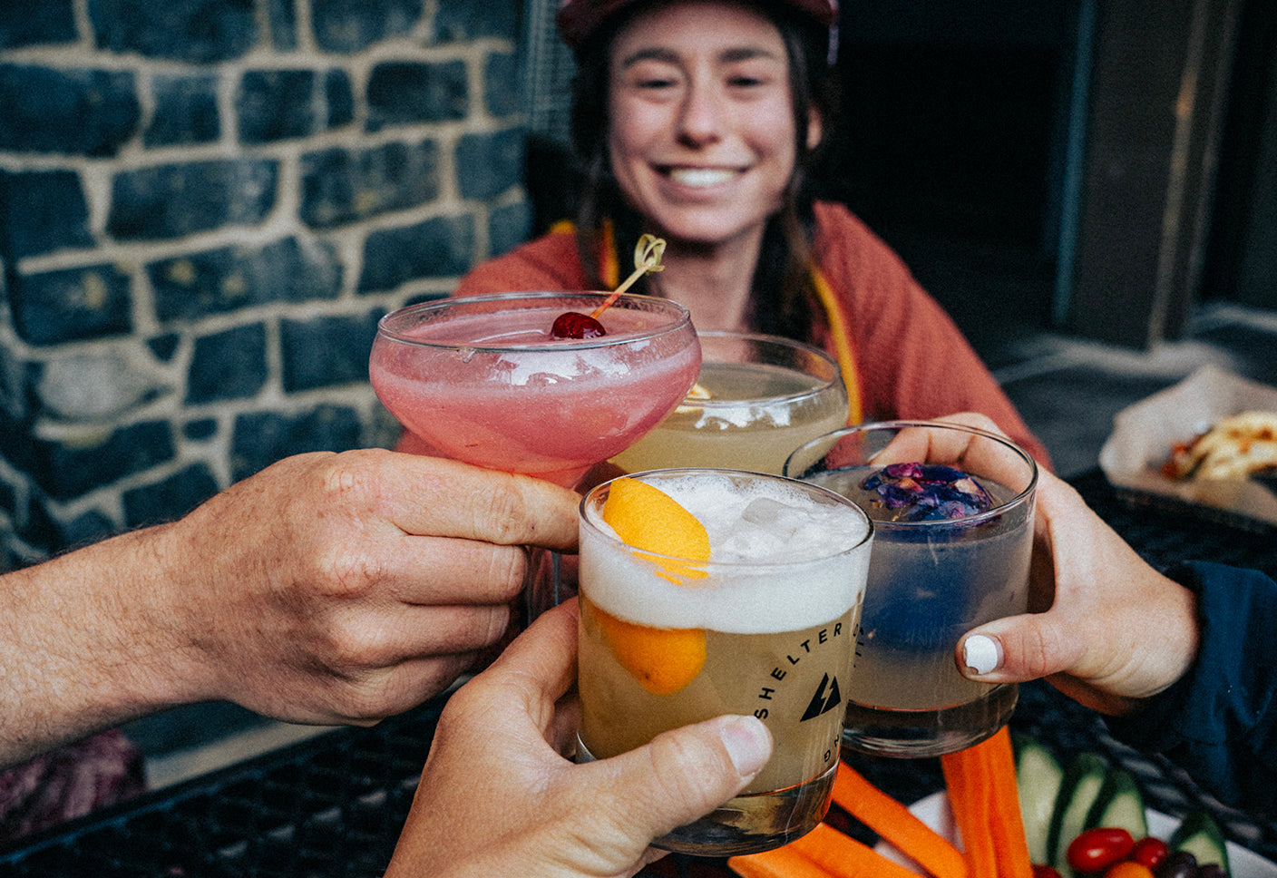 People toasting with craft cocktails at Shelter Distilling in Mammoth Lakes, CA. Craft cocktail bar in Mammoth Lakes