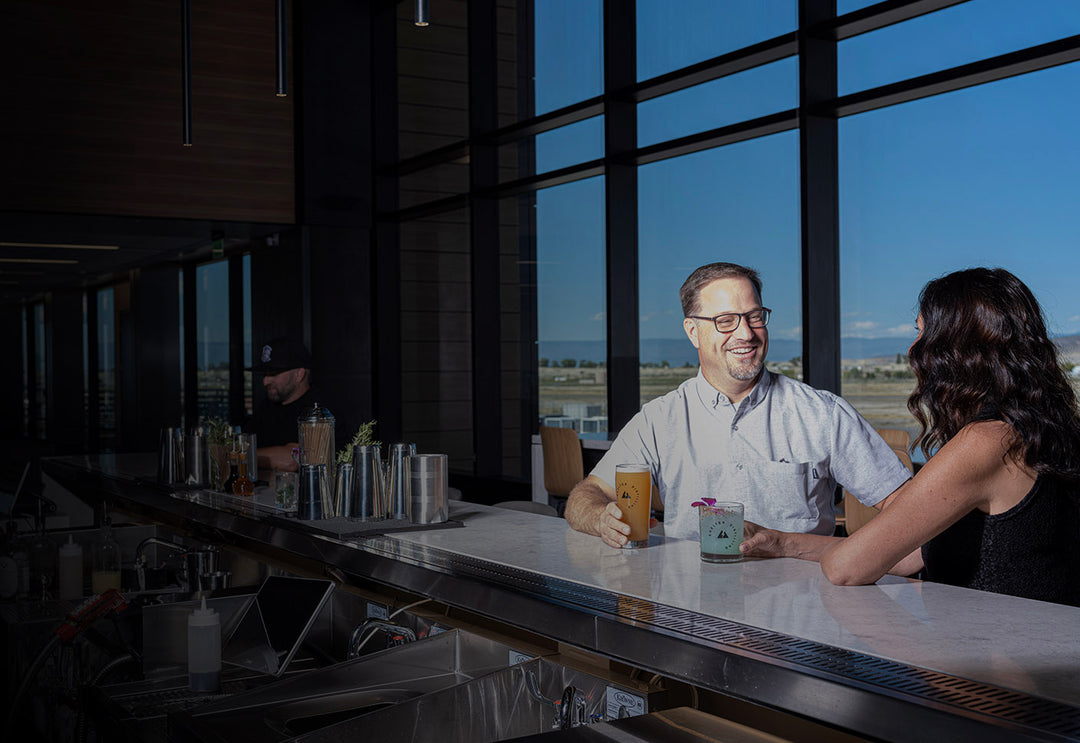 Setting at Shelter Distilling bar in the Montrose, CO, Regional Airport. Located upstairs at gates 5 & 6. Specialty cocktails and craft beer.