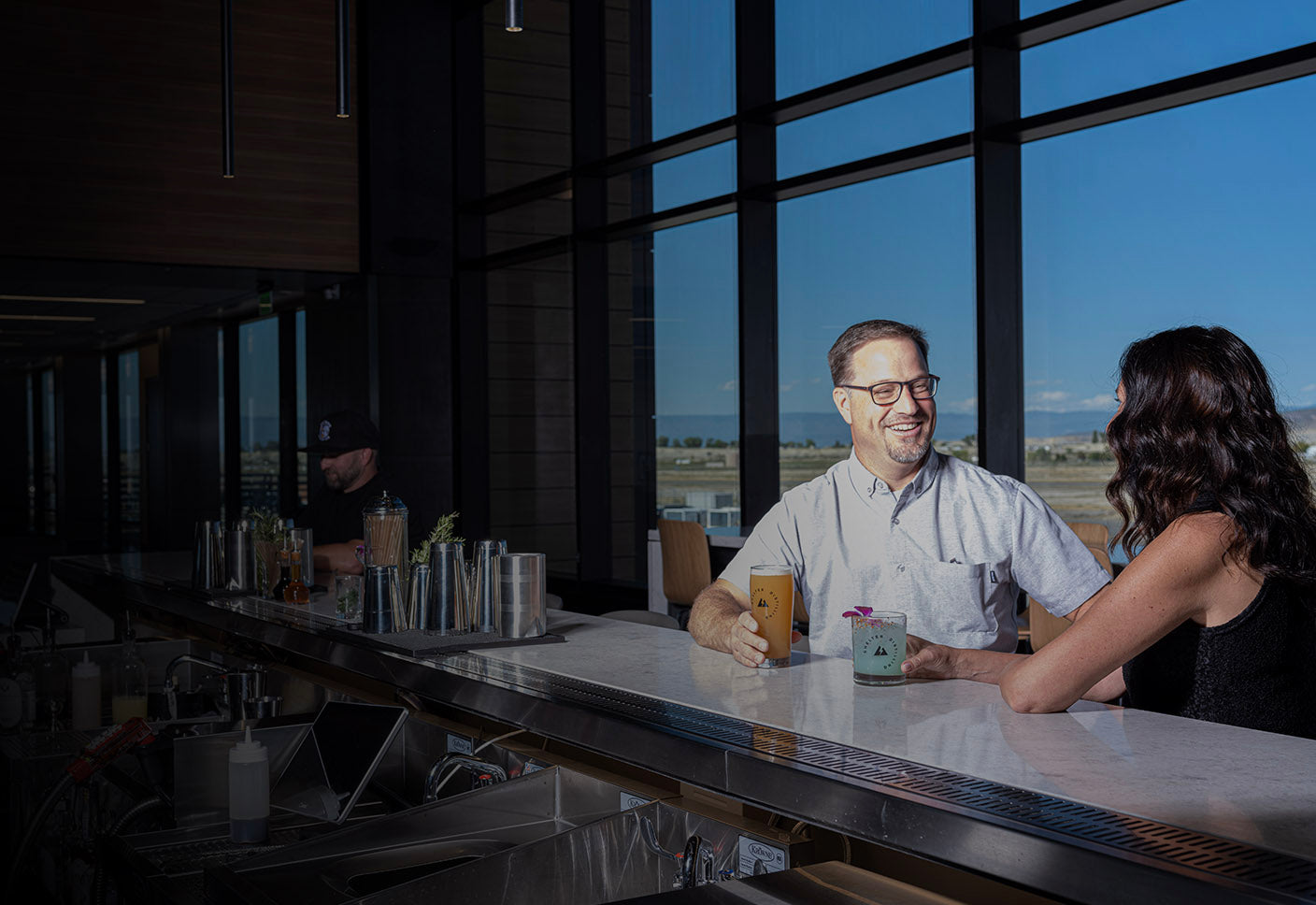 Setting at Shelter Distilling bar in the Montrose, CO, Regional Airport. Located upstairs at gates 5 & 6. Specialty cocktails and craft beer.
